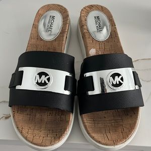Micheal Kors Slides, size 81/2 black with white trim on the slight wedge